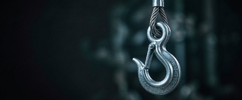 Forged eye hook with safety latch hanging on steel wire rope