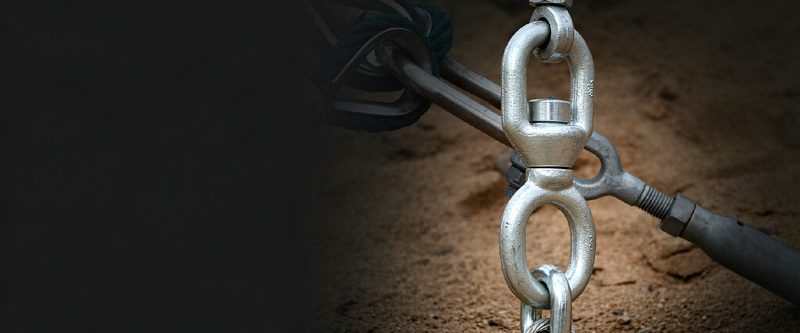 Galvanized swivel connected to turnbuckle and chain on sand
